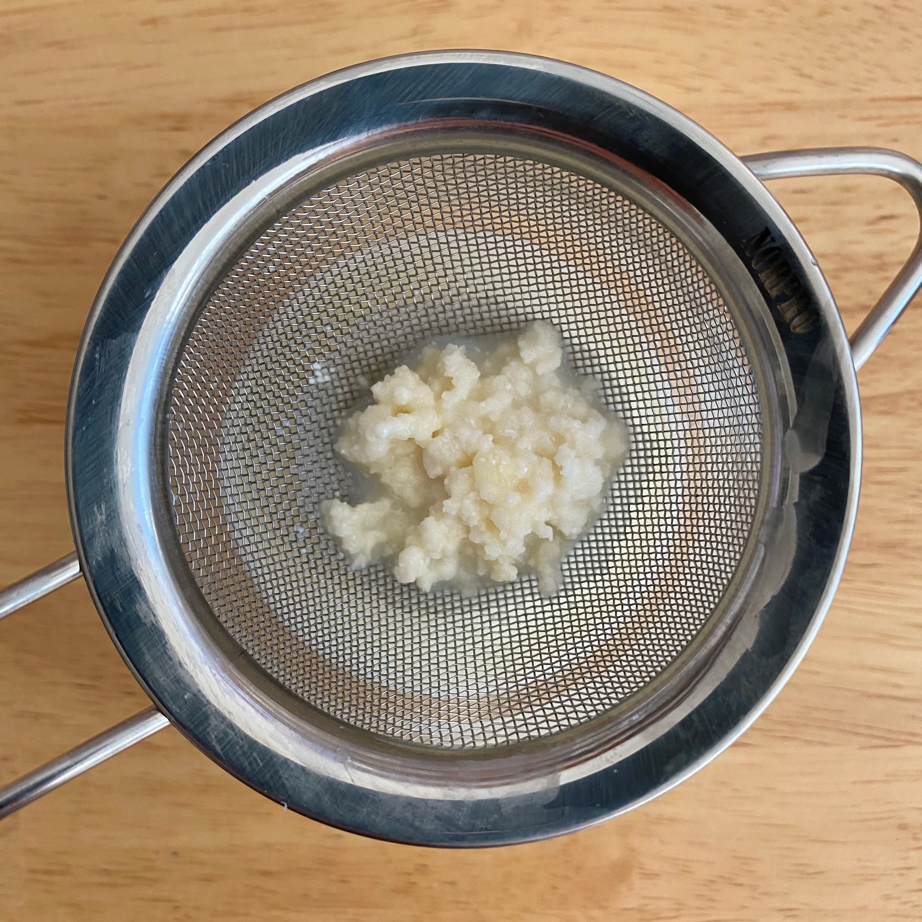 Milk kefir grains in a strainer